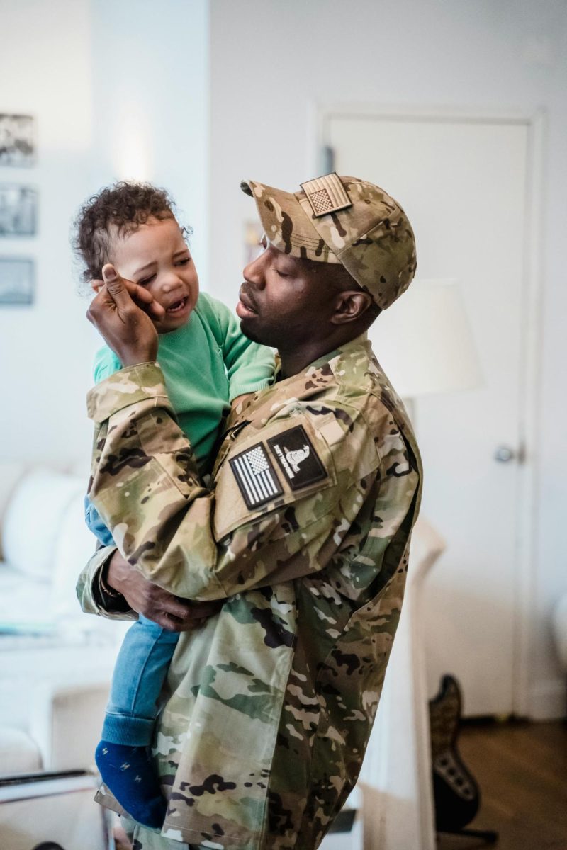 An Army dad comforts his toddler son. 