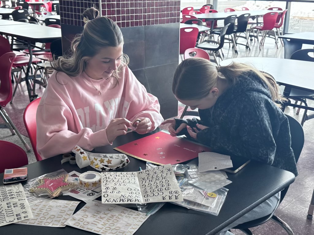 Tensley Davis and Clara Fain working on the Beta scrapbook.
